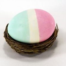 Tri-colored striped Easter egg in a nest.
